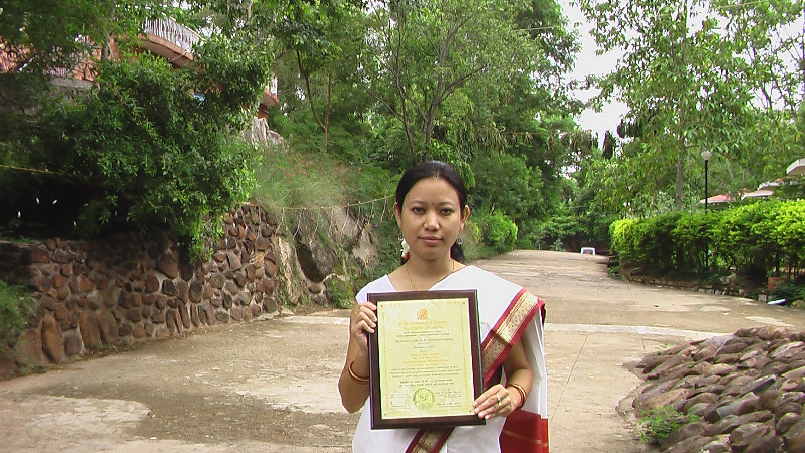 woman holding a certificate of education