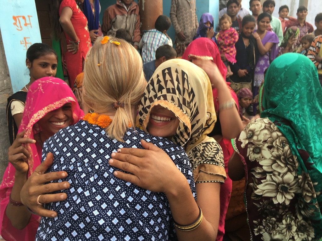 woman smiling and hugging each other