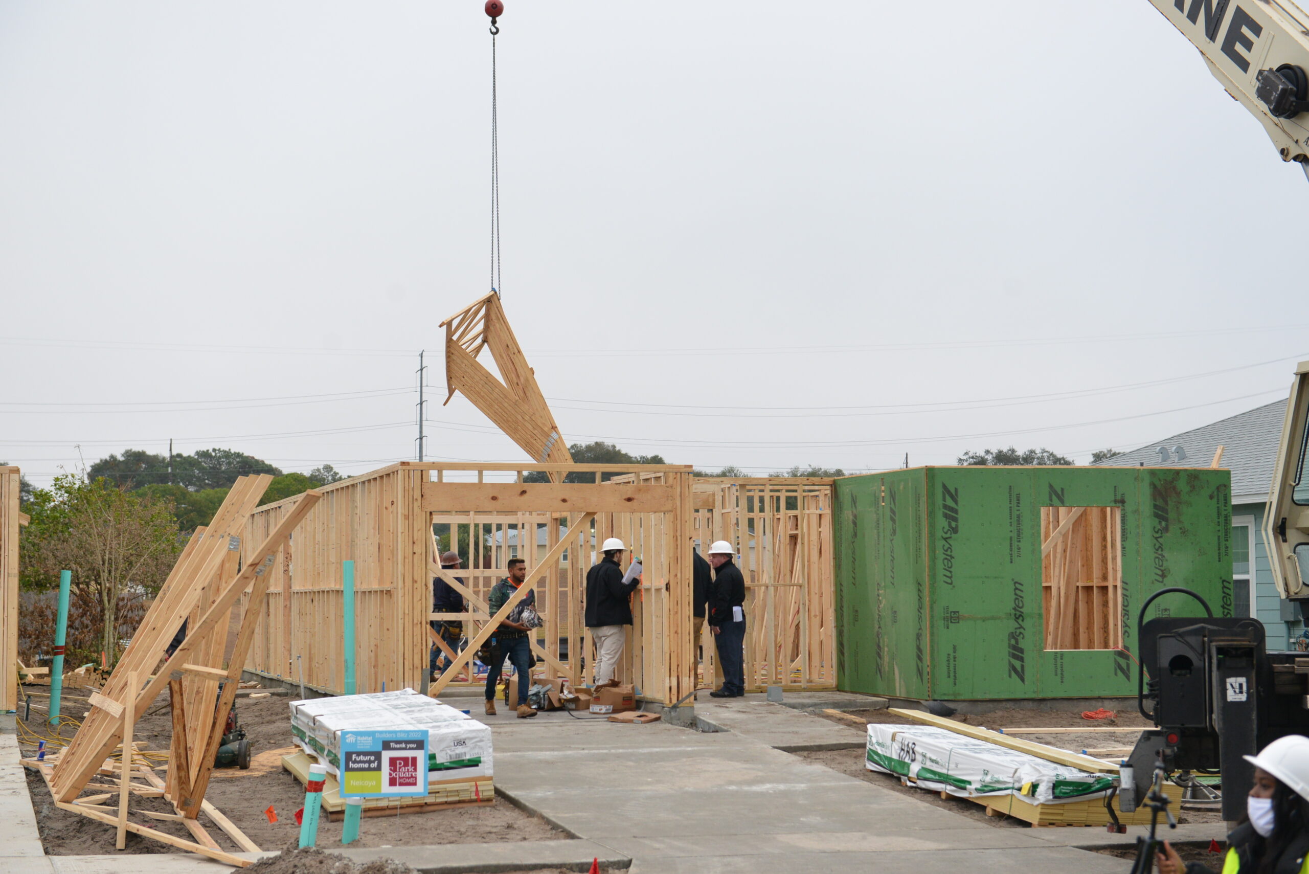 builders working on the frame of a new home under construction