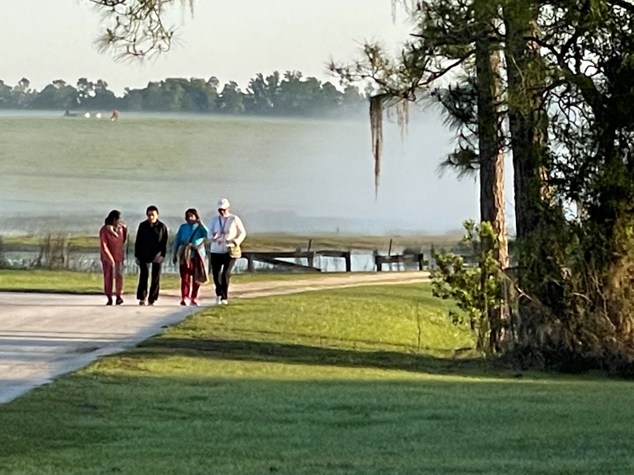 people walking along a trail next to a lake at Pine Lake Retreat