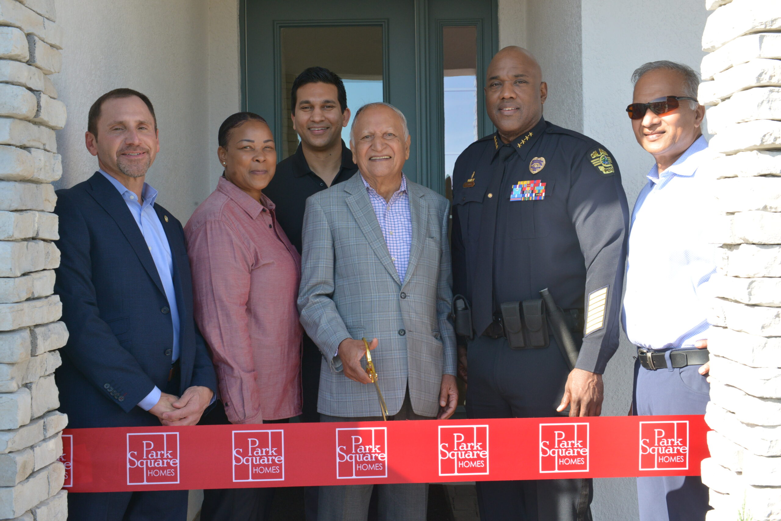 Braham Aggarwal cuts the ribbon of a new home for Park Square Homes