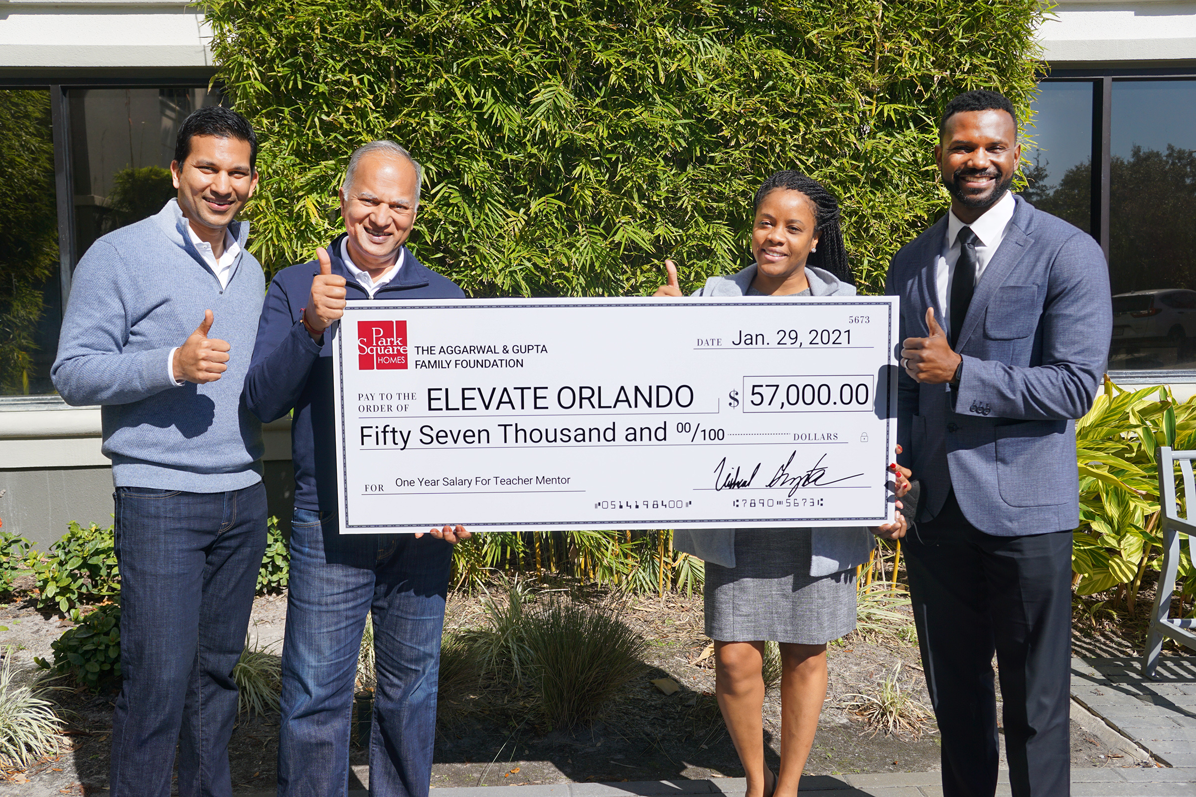 Park Square Homes team holds $57,000 check for Elevate Orlando