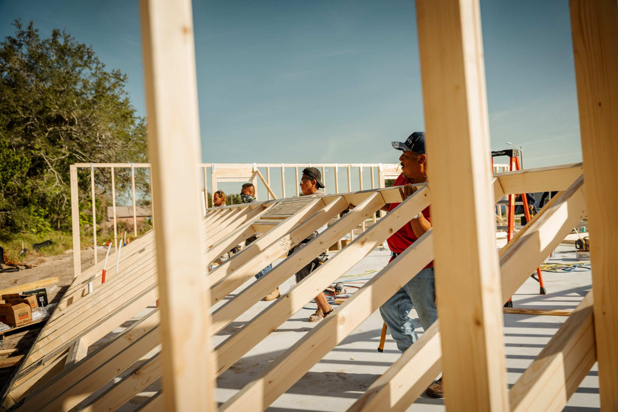 workers raising the frame on a new home