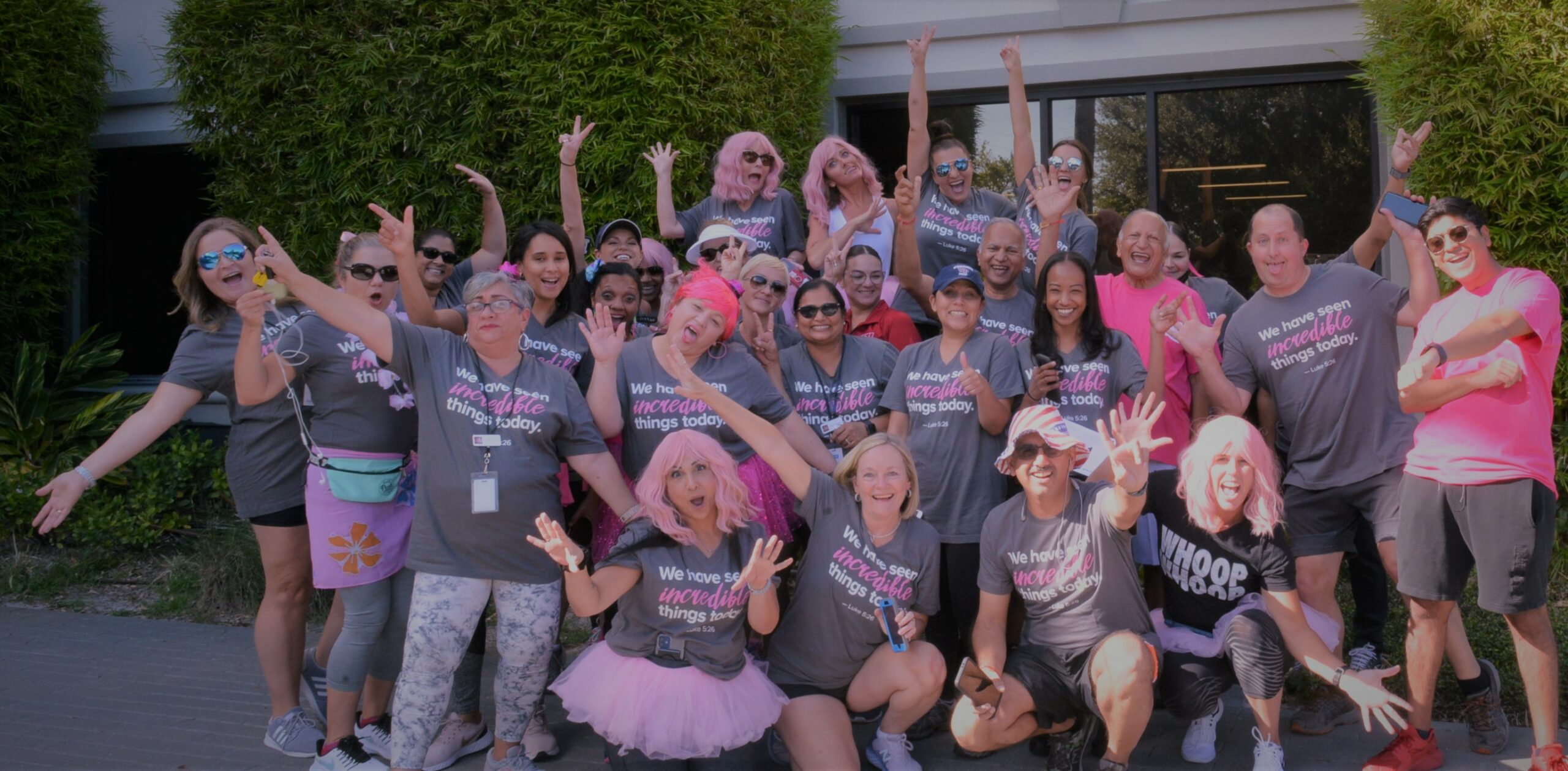 crowd of participants in a silly pose wearing outfits supporting Adventhealth Pink on Parade