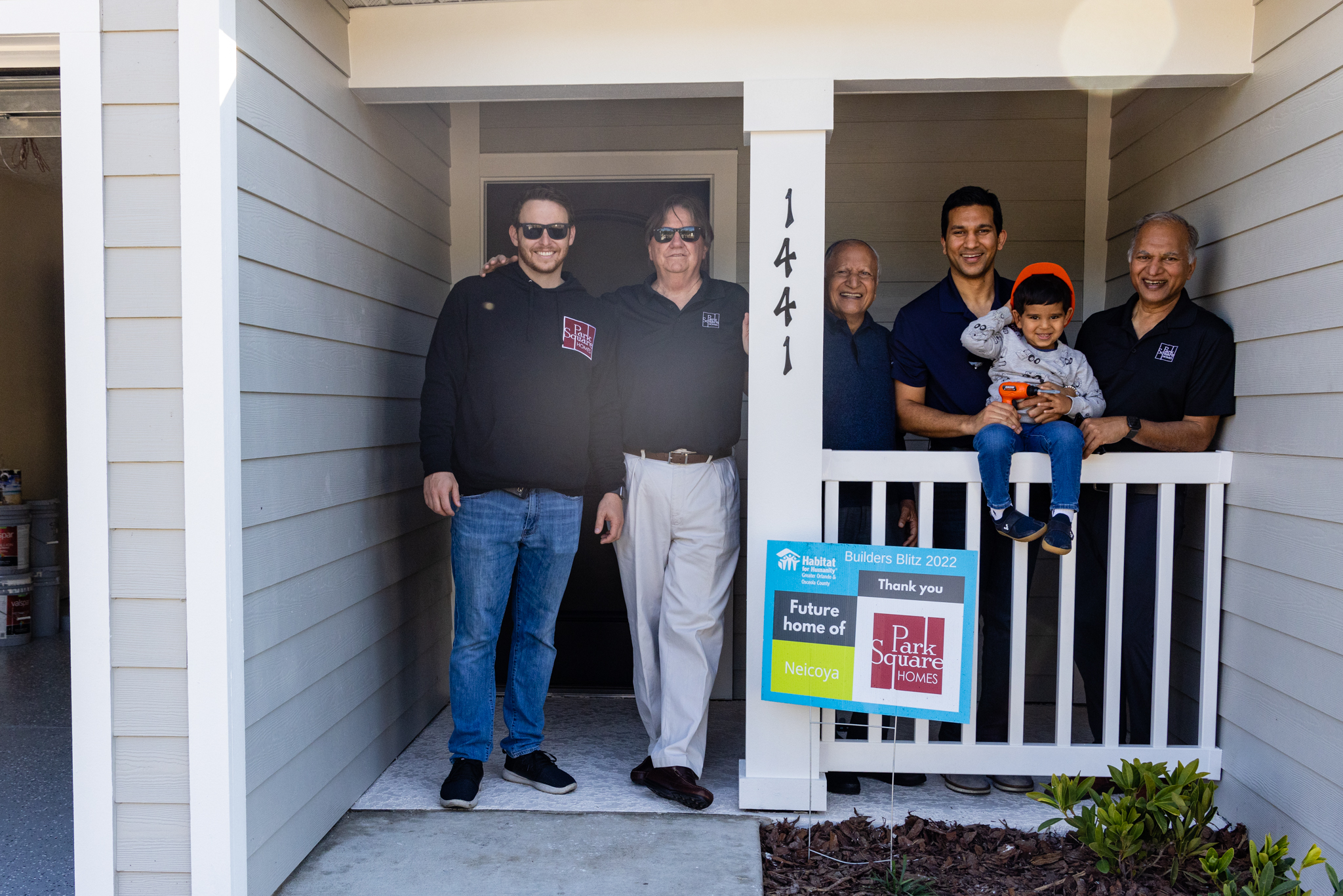 Park Square Homes team pose on the front porch of a new home