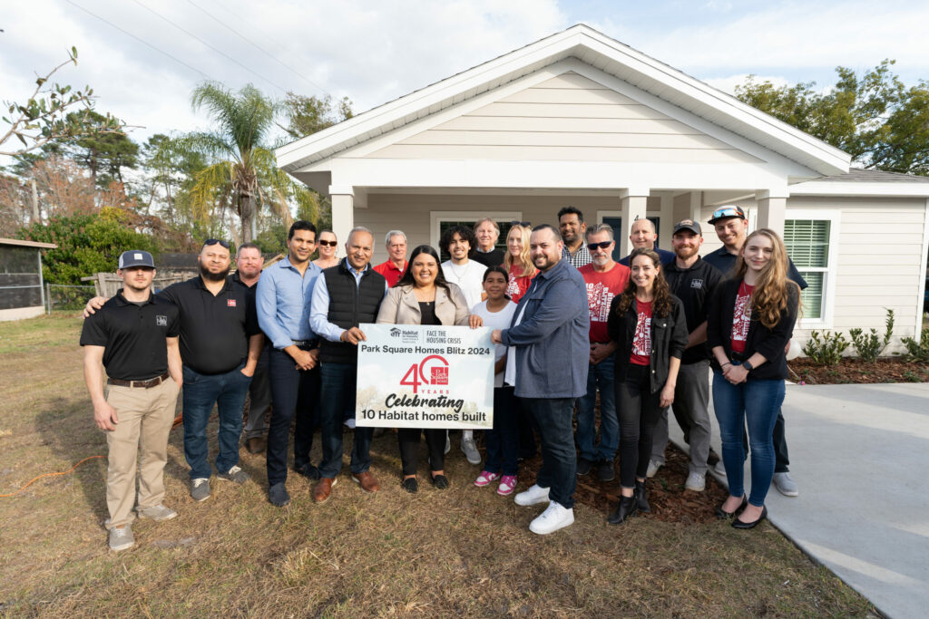 foundation members stand outside of a new home for Habitat for Humanity sponsored by Park Square Homes