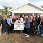 foundation members stand outside of a new home for Habitat for Humanity sponsored by Park Square Homes